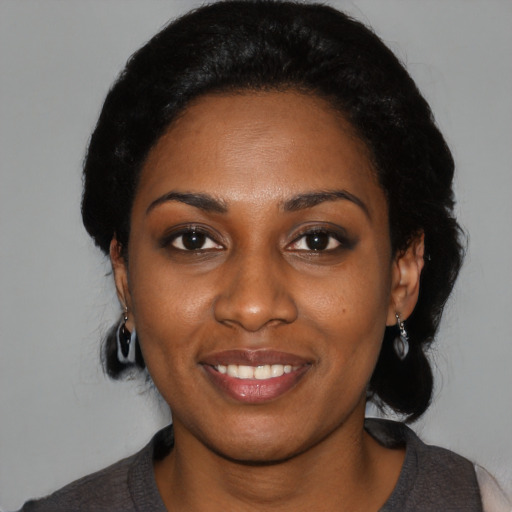 Joyful black young-adult female with medium  black hair and brown eyes