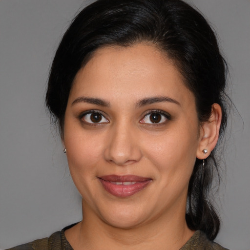 Joyful latino young-adult female with medium  brown hair and brown eyes