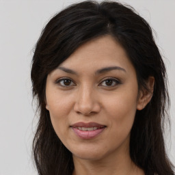 Joyful latino young-adult female with long  brown hair and brown eyes