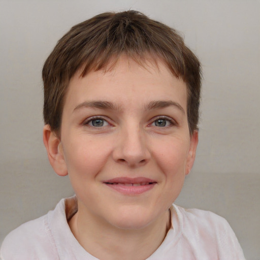 Joyful white child female with short  brown hair and grey eyes