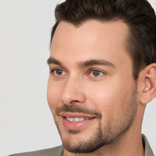 Joyful white young-adult male with short  brown hair and brown eyes