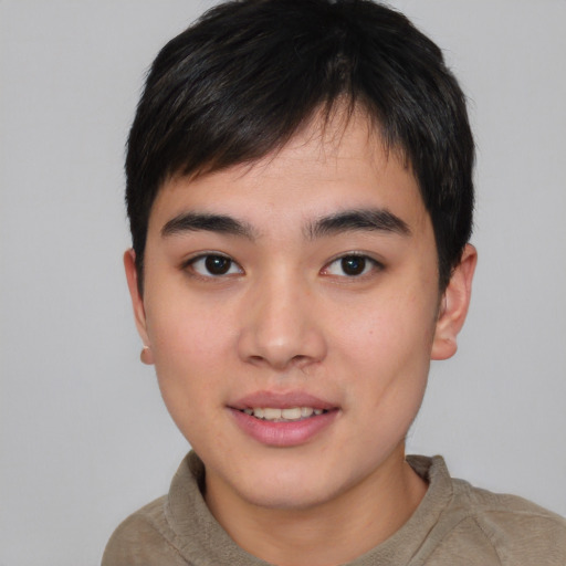 Joyful asian young-adult male with short  brown hair and brown eyes