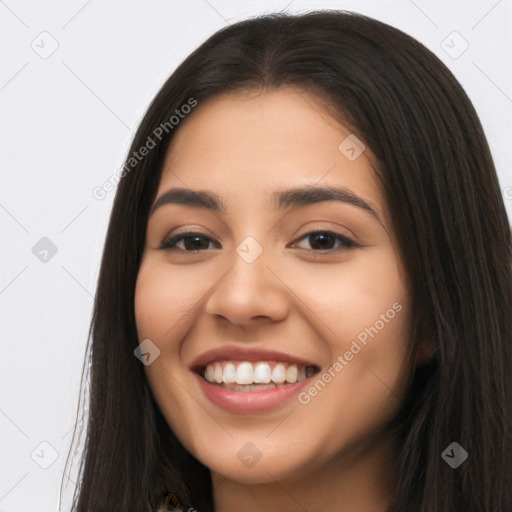 Joyful latino young-adult female with long  brown hair and brown eyes