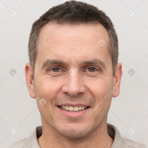 Joyful white adult male with short  brown hair and brown eyes