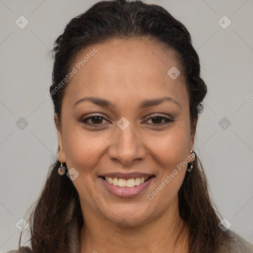 Joyful black adult female with long  brown hair and brown eyes