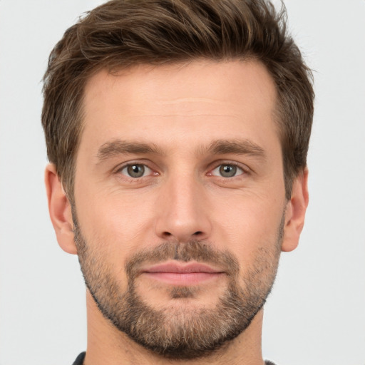 Joyful white young-adult male with short  brown hair and brown eyes