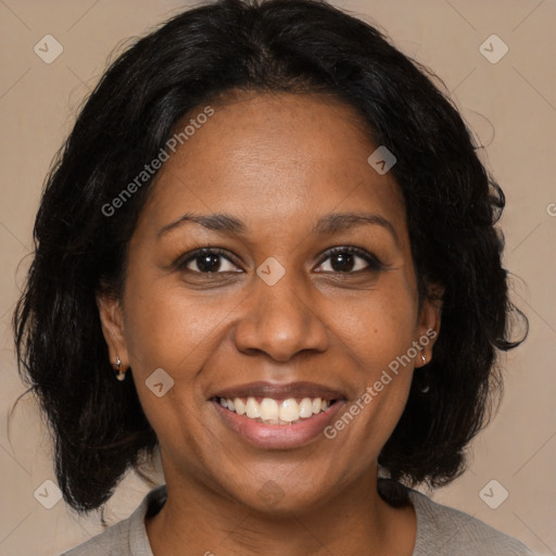 Joyful black adult female with medium  brown hair and brown eyes