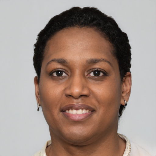 Joyful black young-adult female with short  brown hair and brown eyes