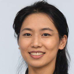 Joyful asian young-adult female with long  brown hair and brown eyes