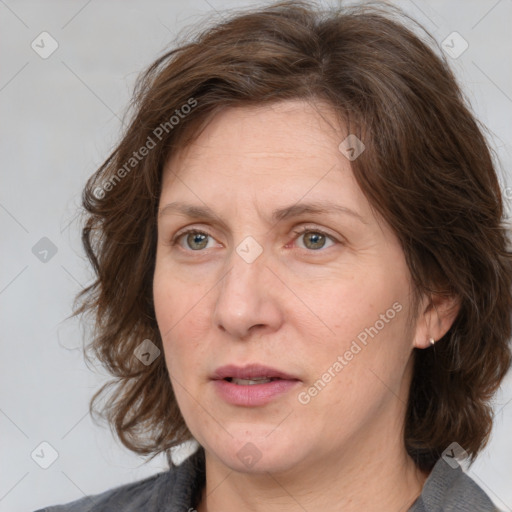 Joyful white adult female with medium  brown hair and grey eyes