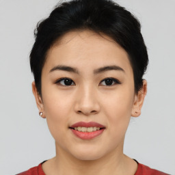 Joyful asian young-adult female with short  black hair and brown eyes