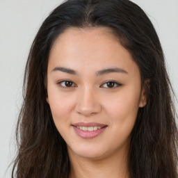 Joyful asian young-adult female with long  brown hair and brown eyes