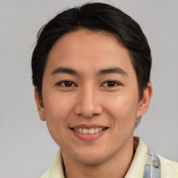 Joyful asian young-adult male with short  brown hair and brown eyes