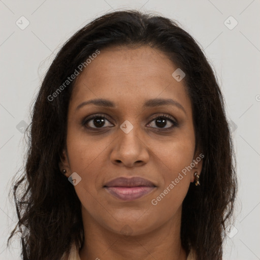 Joyful black young-adult female with long  brown hair and brown eyes