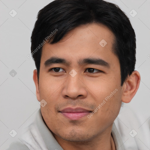 Joyful asian young-adult male with short  black hair and brown eyes