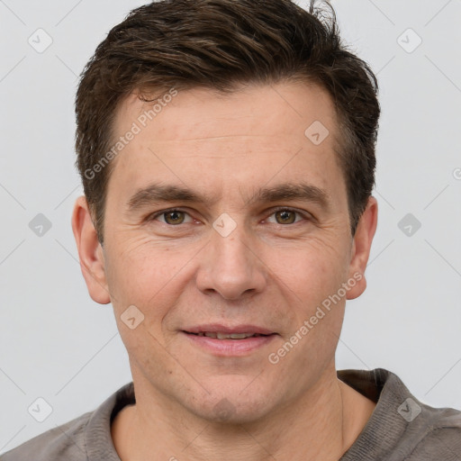 Joyful white adult male with short  brown hair and grey eyes