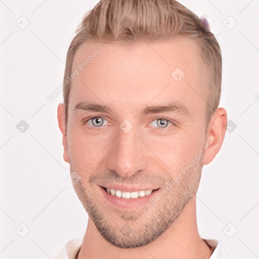 Joyful white young-adult male with short  brown hair and grey eyes