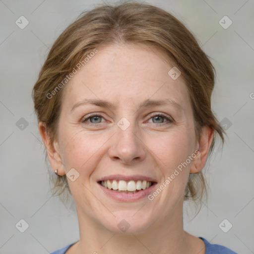 Joyful white adult female with medium  brown hair and blue eyes