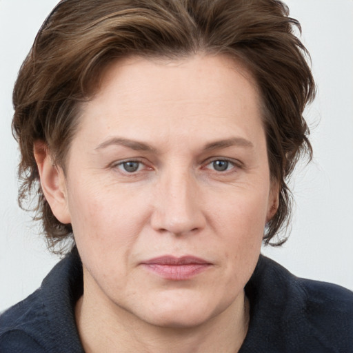 Joyful white adult female with medium  brown hair and grey eyes