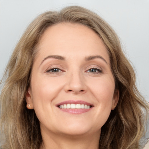 Joyful white young-adult female with long  brown hair and grey eyes