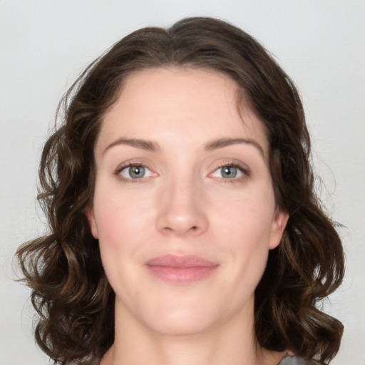 Joyful white young-adult female with medium  brown hair and green eyes