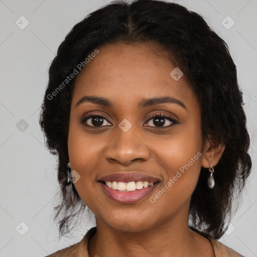 Joyful black young-adult female with long  black hair and brown eyes