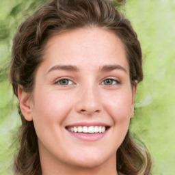 Joyful white young-adult female with long  brown hair and green eyes