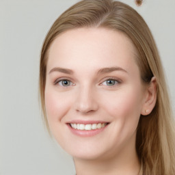 Joyful white young-adult female with long  brown hair and blue eyes