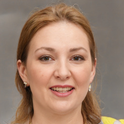 Joyful white adult female with medium  brown hair and brown eyes