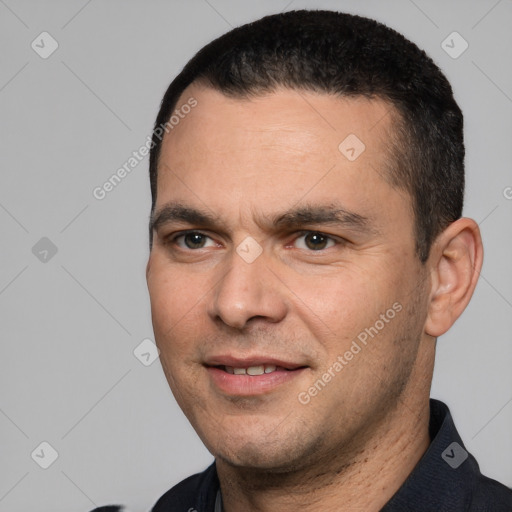 Joyful white adult male with short  black hair and brown eyes