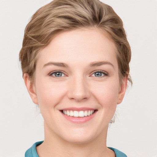 Joyful white young-adult female with short  brown hair and grey eyes