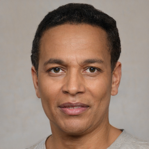 Joyful latino adult male with short  black hair and brown eyes