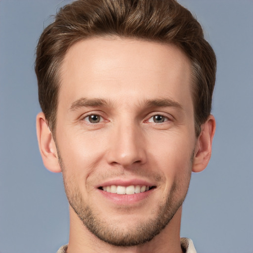 Joyful white young-adult male with short  brown hair and grey eyes