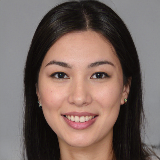 Joyful asian young-adult female with long  brown hair and brown eyes