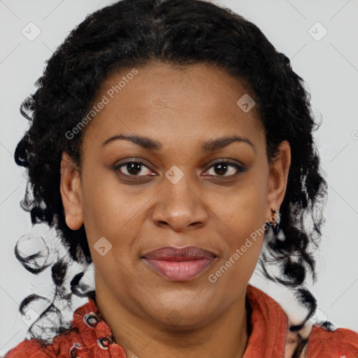 Joyful black adult female with medium  brown hair and brown eyes