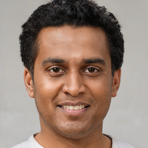 Joyful latino adult male with short  black hair and brown eyes