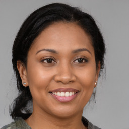 Joyful latino young-adult female with medium  brown hair and brown eyes