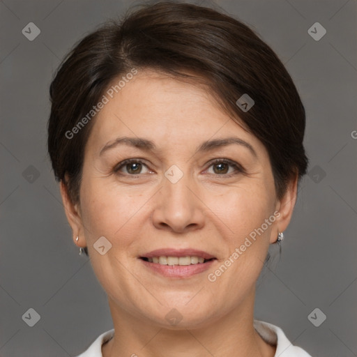 Joyful white adult female with short  brown hair and brown eyes