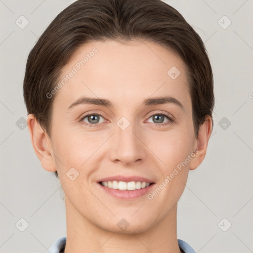 Joyful white young-adult female with short  brown hair and grey eyes