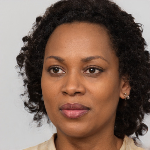 Joyful black adult female with medium  black hair and brown eyes