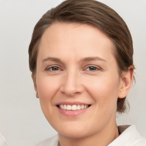 Joyful white young-adult female with medium  brown hair and brown eyes