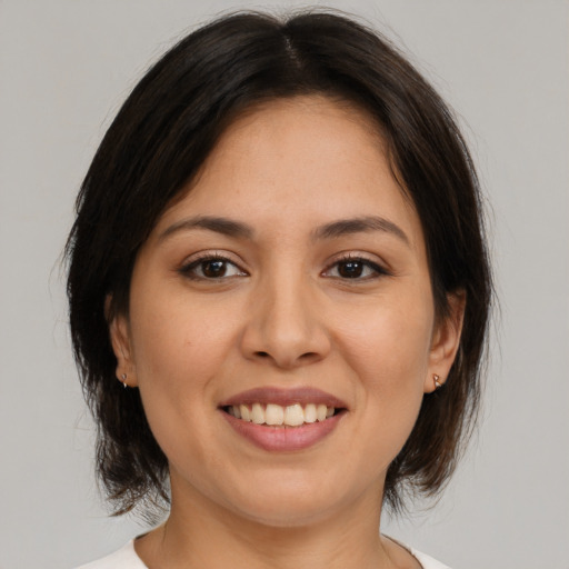 Joyful white young-adult female with medium  brown hair and brown eyes
