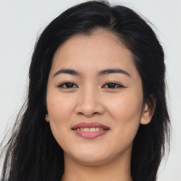 Joyful asian young-adult female with long  brown hair and brown eyes