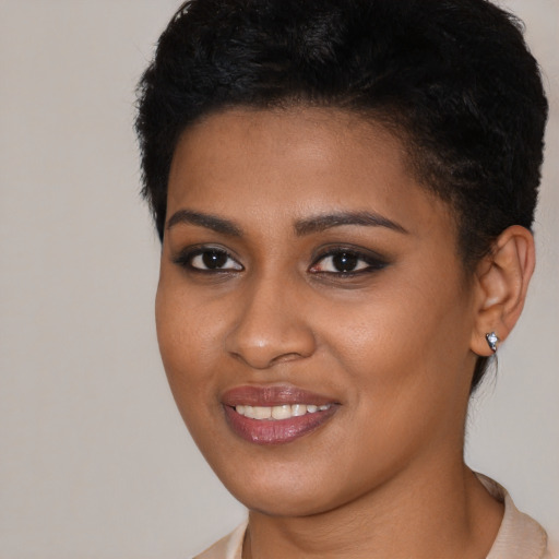 Joyful black young-adult female with medium  black hair and brown eyes