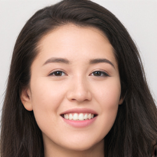 Joyful white young-adult female with long  brown hair and brown eyes