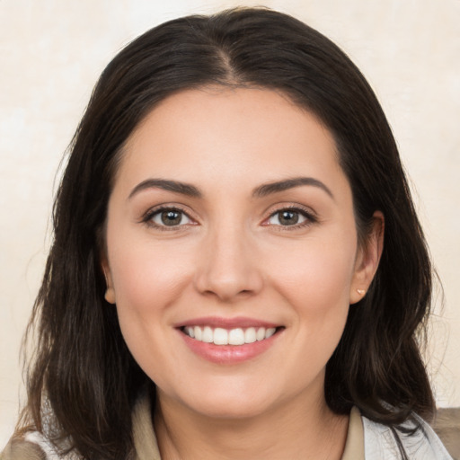 Joyful white young-adult female with medium  brown hair and brown eyes