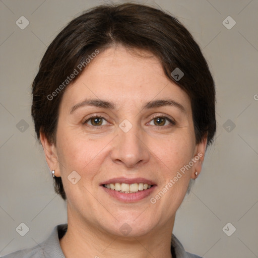 Joyful white adult female with short  brown hair and brown eyes