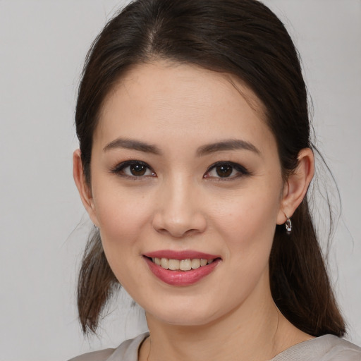 Joyful white young-adult female with medium  brown hair and brown eyes