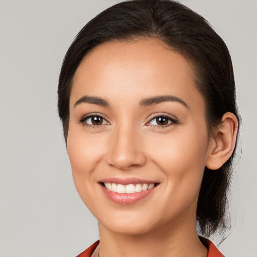 Joyful white young-adult female with long  brown hair and brown eyes