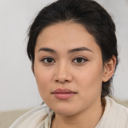 Joyful latino young-adult female with medium  brown hair and brown eyes